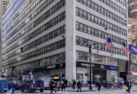 An exterior view of a tall commercial building with a gray facade, American flags, and ground-level retail tenants like Duane Reade, Chase Bank, and others in an urban street setting—I have generated SEO-optimized and accessibility-compliant metadata. These incorporate relevant keywords (e.g., "1430 Broadway exterior," "NYC commercial building facade") to improve search visibility, while adhering to WCAG 2.2 standards for alt text. The metadata is tailored to the 1430 Broadway property managed by Steinberg & Pokoik. Alt Text Concise and descriptive for screen readers, capturing essential visual elements and context.